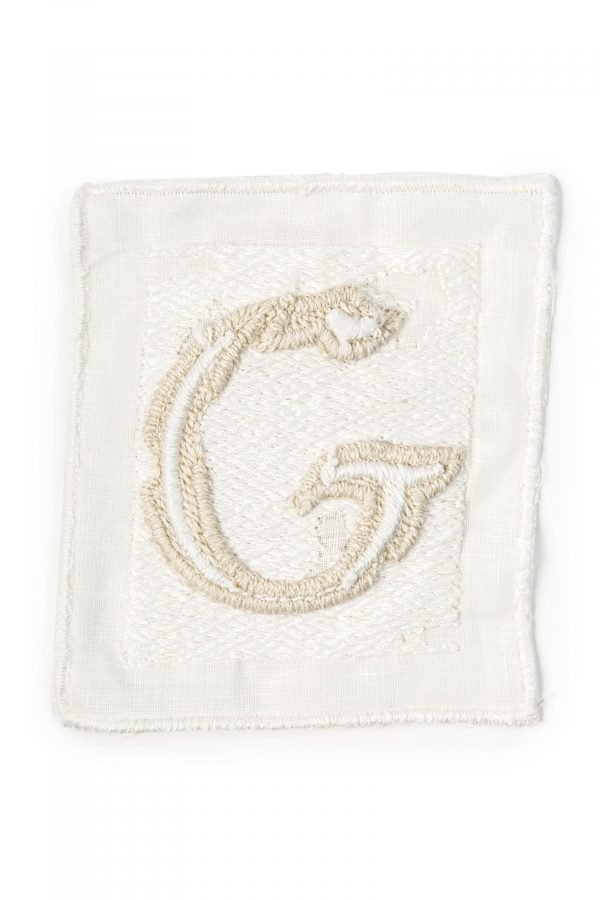 Letter G embroidered on linen